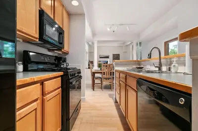 a kitchen with a sink and a stove top oven at Quiet Urban Escape - Backs to Poudre River Trail! in Fort Collins