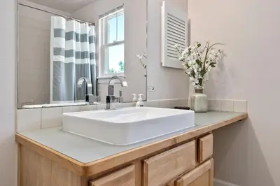 a bathroom with a white sink and a mirror at Quiet Urban Escape - Backs to Poudre River Trail! in Fort Collins
