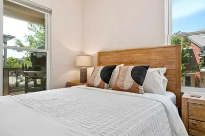 a bedroom with a bed and a large window at Quiet Urban Escape - Backs to Poudre River Trail! in Fort Collins