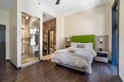 a bedroom with a bed and a green headboard at Good Hotels Downtown Denver in Denver