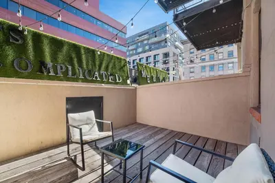 a balcony with a chair and a fireplace at Good Hotels Downtown Denver in Denver