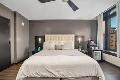 a large bedroom with a large bed with white sheets at Good Hotels Downtown Denver in Denver