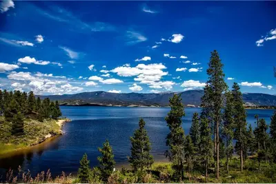 a view of a lake with trees on the shore at K-Suite-Mt View-Resort-Pool-Hot Tub-Near RMNP & WP in Granby