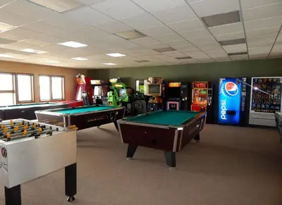 a gaming room with pool tables and arcade machines at K-Suite-Mt View-Resort-Pool-Hot Tub-Near RMNP & WP in Granby
