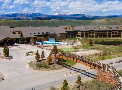a bridge over a road in front of a building at K-Suite-Mt View-Resort-Pool-Hot Tub-Near RMNP & WP in Granby