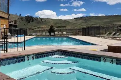 a large swimming pool with blue water at K-Suite-Mt View-Resort-Pool-Hot Tub-Near RMNP & WP in Granby