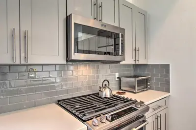 a kitchen with a stove top and a microwave at Modern Denver Townhome with Rooftop Terrace! in Denver