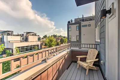 a balcony with a chair and a view of the city at Modern Denver Townhome with Rooftop Terrace! in Denver