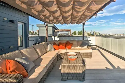 a couch on the deck of a house at Modern Denver Townhome with Rooftop Terrace! in Denver