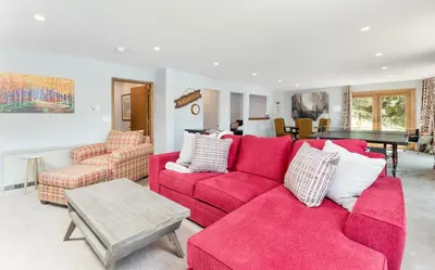 a living room with a red couch and chairs at Trails End Vacation Home at Windcliff home in Estes Park