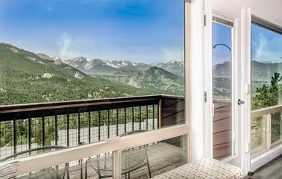 a balcony with a view of mountains at Trails End Vacation Home at Windcliff home in Estes Park