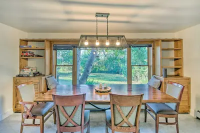 a dining room with a wooden table and chairs at Moose Park Lodge Charming Walden Retreat! in Walden