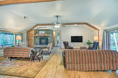 a living room with a couch and a fireplace at Moose Park Lodge Charming Walden Retreat! in Walden