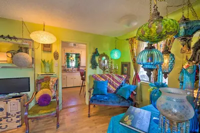 a living room filled with lots of different colored glass items at Walk to Old Town Arvada - 1940 Vintage Bungalow! in Arvada
