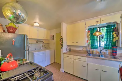a kitchen with a sink and a stove top oven at Walk to Old Town Arvada - 1940 Vintage Bungalow! in Arvada