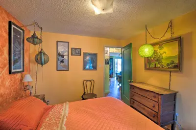 a bedroom with a bed and a dresser in it at Walk to Old Town Arvada - 1940 Vintage Bungalow! in Arvada