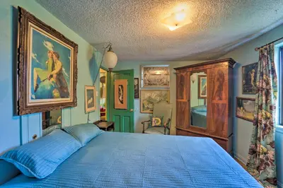 a bedroom with a blue bed in a room at Walk to Old Town Arvada - 1940 Vintage Bungalow! in Arvada