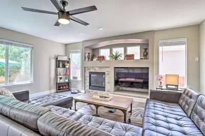 a living room with a couch and a fireplace at Spacious Parkview Home Near Denver with Game Room in Thornton