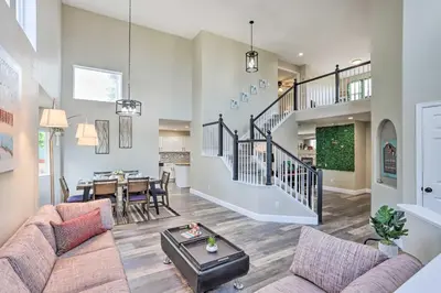 a living room with a couch and a table at Spacious Parkview Home Near Denver with Game Room in Thornton