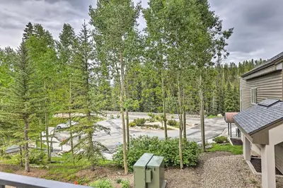 a view of a yard with trees and a house at Ski-InandSki-Out Studio at Winter Park Base! in Winter Park