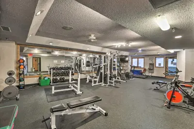 a gym with several treadmills and machines at Ski-InandSki-Out Studio at Winter Park Base! in Winter Park