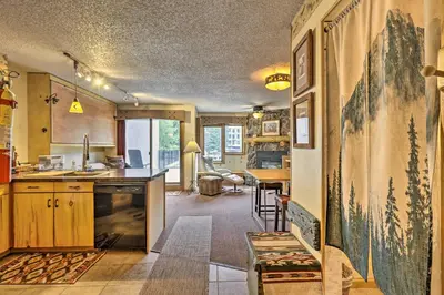 a kitchen and living room with a table and chairs at Ski-InandSki-Out Studio at Winter Park Base! in Winter Park