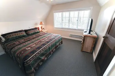 a bedroom with a bed and a window and a television at Aspen Mountain Lodge - #3357 in Estes Park