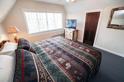 a bedroom with a large bed and a window at Aspen Mountain Lodge - #3357 in Estes Park