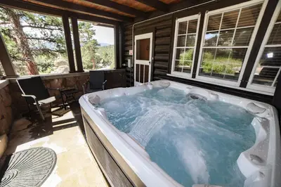 a jacuzzi tub in a house with windows at Aspen Mountain Lodge - #3357 in Estes Park