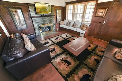 a living room with a leather couch and a fireplace at Aspen Mountain Lodge - #3357 in Estes Park
