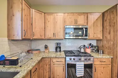 a kitchen with wooden cabinets and a stove top oven at Updated Mtn Home about 6 Mi to Winter Park Resort in Fraser
