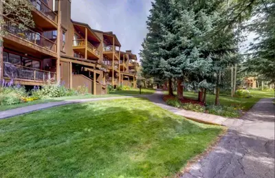 a large apartment building with a lawn in front of it at 1 Bedroom Condo In West Keystone Near Lakeside Village in Keystone