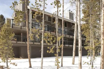 an apartment building with trees in the snow at 1 Bedroom Condo In West Keystone Near Lakeside Village in Keystone