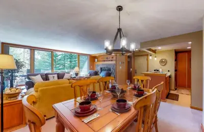 a dining room and living room with a table and chairs at 1 Bedroom Condo In West Keystone Near Lakeside Village in Keystone