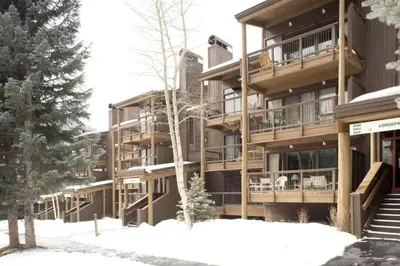 a large apartment building with snow in front of it at 1 Bedroom Condo In West Keystone Near Lakeside Village in Keystone