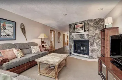 a living room with a couch and a fireplace at 2 Bedroom Condo In West Keystone Near Lakeside Village in Keystone