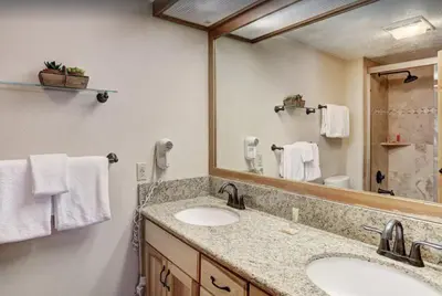 a bathroom with two sinks and a large mirror at 2 Bedroom Condo In West Keystone Near Lakeside Village in Keystone
