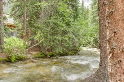 a river in the middle of a forest at 3 Bedroom Condo In West Keystone Near Lakeside Village in Keystone