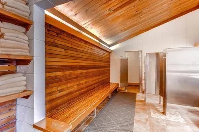 a kitchen with a wooden wall with a refrigerator at 3 Bedroom Condo In West Keystone Near Lakeside Village in Keystone