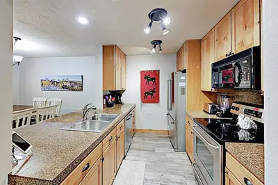 a kitchen with a sink and a refrigerator at 3 Bedroom Condo In West Keystone Near Lakeside Village in Keystone