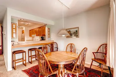 a kitchen and dining room with a wooden table and chairs at North Keystone 1 Bedroom Near Conference Center in Keystone