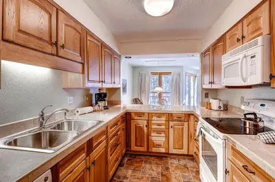 a kitchen with wooden cabinets and a sink at North Keystone 1 Bedroom Near Conference Center in Keystone
