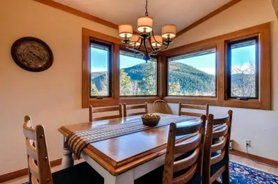 a dining room with a table and some windows at North Keystone 2 Bedroom Near Conference Center in Keystone