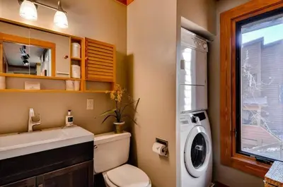 a bathroom with a toilet and a washing machine at North Keystone 2 Bedroom Near Conference Center in Keystone