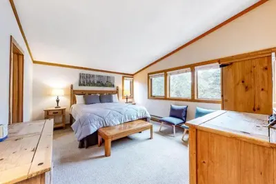 a bedroom with a bed and a chair in a room at North Keystone 3 Bedroom Near Conference Center in Keystone