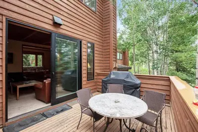 a patio with a table and chairs on a deck at North Keystone 3 Bedroom Near Conference Center in Keystone