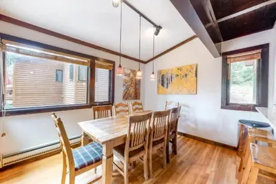 a dining room with a wooden table and chairs at North Keystone 3 Bedroom Near Conference Center in Keystone