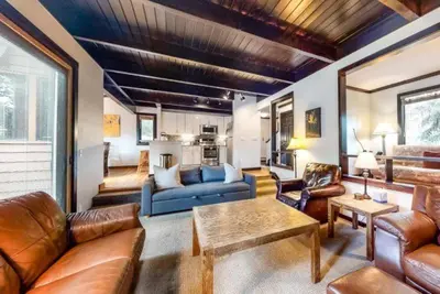 a living room with a blue couch and leather furniture at North Keystone 3 Bedroom Near Conference Center in Keystone