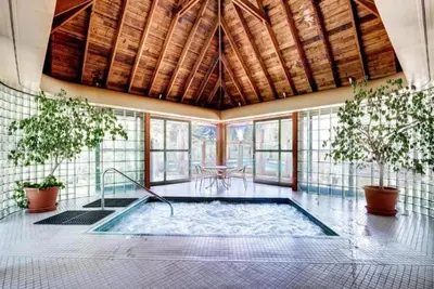 a pool in a room with plants and a table at Soda Springs 1 Bedroom Townhome in Keystone