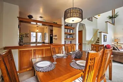 a dining room with a wooden table and chairs at Soda Springs 1 Bedroom Townhome in Keystone